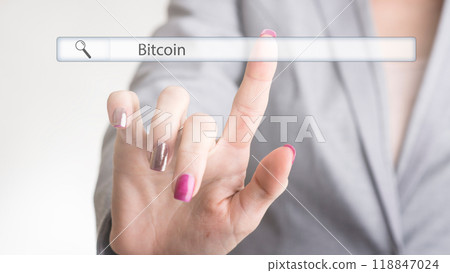Female hand touching a web search bar with the word Bitcoin 118847024