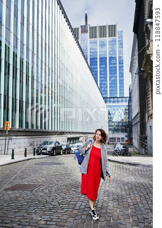 a woman in a red dress in the downtown of Brussels a woman in a red dress in the downtown of Brussels 118847593
