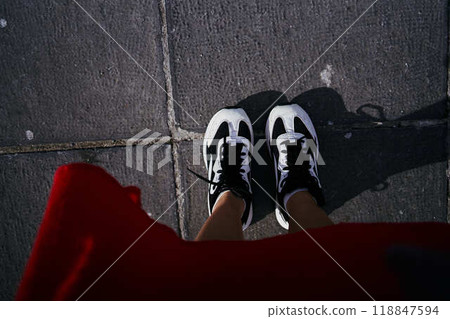 a woman in a red dress in the downtown of Brussels 118847594