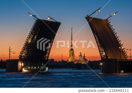 raised bascule Palace Bridge in St. Petersburg on a white night, the Peter and Paul Cathedral is visible in the background raised bascule Palace Bridge in St. Petersburg on a white night, the Peter and Paul Cathedral is visible in the background 118848111
