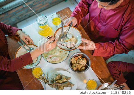 Enjoy a traditional family meal with diverse dishes and refreshing drinks for all Enjoy a traditional family meal with diverse dishes and refreshing drinks for all 118848256