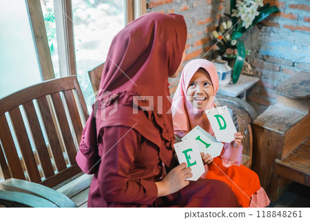 Celebrating Eid Cherishing Joyful Moments Shared Between Mother and Daughter Celebrating Eid Cherishing Joyful Moments Shared Between Mother and Daughter 118848261