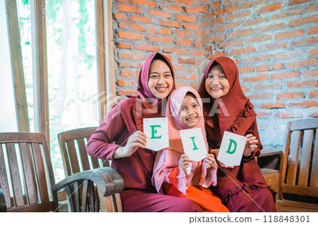 A Happy Family Celebrating Eid with Joyful Smiles and Enthusiastic Festive Spirit A Happy Family Celebrating Eid with Joyful Smiles and Enthusiastic Festive Spirit 118848301