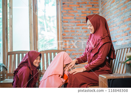 Joyful and Cherished Moments of Girls Dress in Beautiful Traditional Attire at Home Joyful and Cherished Moments of Girls Dress in Beautiful Traditional Attire at Home 118848308