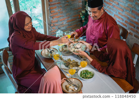 A Joyful Family Gathering Featuring a Traditional Meal in a Cozy, Inviting Setting 118848450