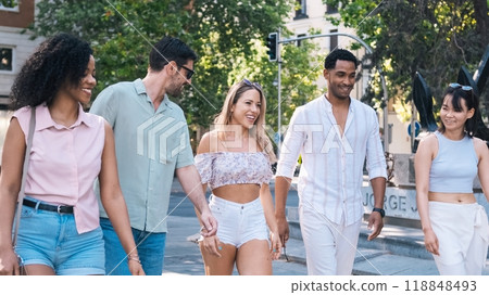 Cheerful diverse friends walking on city street 118848493