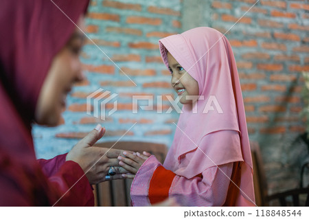 little Asian girl shakes hands and forgives family during Eid Mubarak celebrations little Asian girl shakes hands and forgives family during Eid Mubarak celebrations 118848544