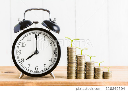 Time is Money: Growing Investment Concept with Clock and Stacked Coins 118849504