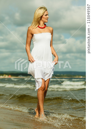 Beautiful blonde girl on beach, summertime Beautiful blonde girl on beach, summertime 118849567