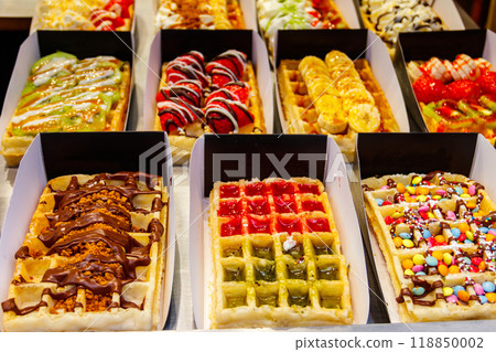 Belgian waffles with colorful sweet toppings and fruits for sale in Brussels, Belgium Belgian waffles with colorful sweet toppings and fruits for sale in Brussels, Belgium 118850002