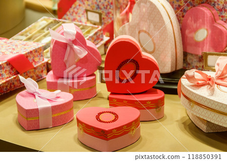 Heart shaped gift boxes on a store display. Valentine Day concept Heart shaped gift boxes on a store display. Valentine Day concept 118850391