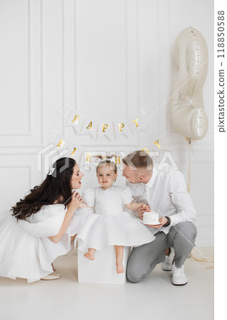 Family celebrating childs second birthday with love and joy 118850588