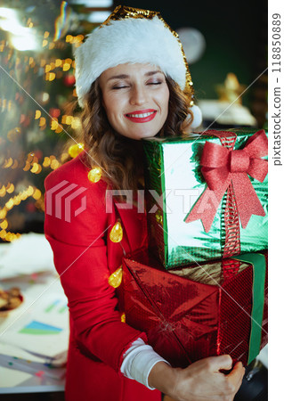smiling business woman in green office with Christmas tree 118850889