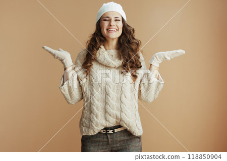 happy stylish woman isolated on beige background catching snow 118850904
