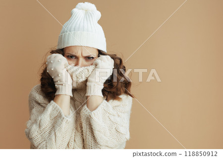 sad stylish woman isolated on beige wrapped in collar 118850912