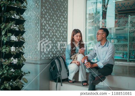 A Casual Conversation Taking Place Between Friends Inside a Modern Urban Setting A Casual Conversation Taking Place Between Friends Inside a Modern Urban Setting 118851081