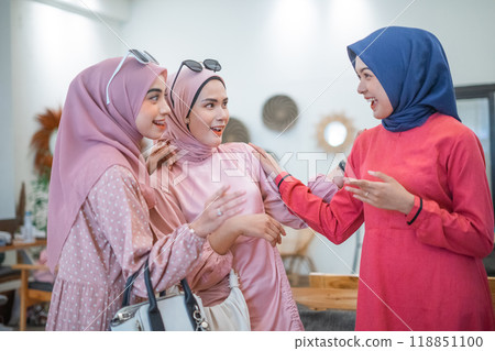 A joyful group of women sharing laughter and fashion moments in unity and happiness 118851100