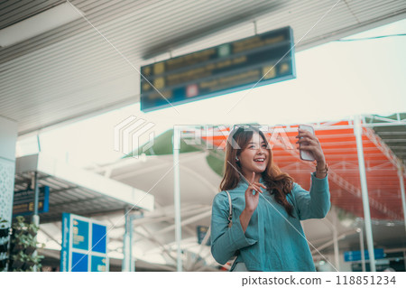 A Young Woman Happily Enjoying Her Exciting Travel Experience at the Airport 118851234