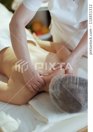 massage therapist in spa salon massaging clients neck 118851312