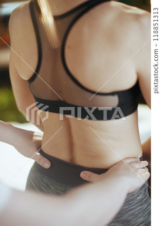 Medical massage therapist checking clients back condition Medical massage therapist checking clients back condition 118851313