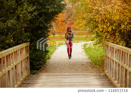 stylish woman in jeans shirt and red hat walking stylish woman in jeans shirt and red hat walking 118851516