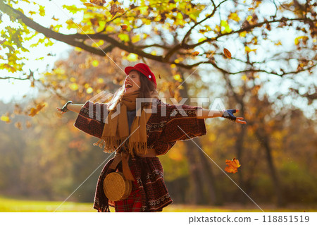 happy stylish female in red hat with scarf rejoicing 118851519