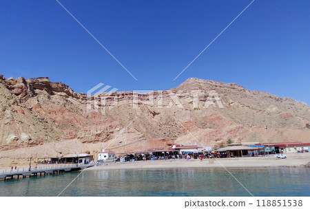 A bay of the Red Sea with a pier and tourists on the shore in the city Sharm el Sheikh A bay of the Red Sea with a pier and tourists on the shore in the city Sharm el Sheikh 118851538