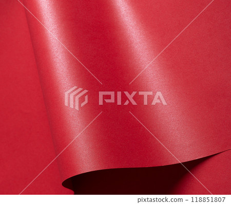 A gorgeous gradient paper with saturated scarlet tones and wavy, curved lines. The glossy surface A gorgeous gradient paper with saturated scarlet tones and wavy, curved lines. The glossy surface 118851807