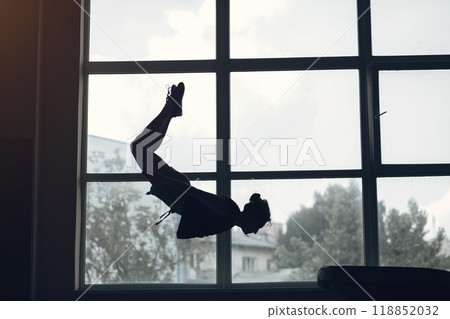 Child gymnastics balance beam. Girl gymnast athlete during an exercise horizontal bar in gymnastics competitions. Child gymnastics balance beam. Girl gymnast athlete during an exercise horizontal bar in gymnastics competitions. 118852032