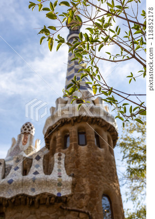 Fairytale gingerbread house in Park Guell designed by Antoni Gaudi in Barcelona, Spain. Focus on a tree Fairytale gingerbread house in Park Guell designed by Antoni Gaudi in Barcelona, Spain. Focus on a tree 118852178