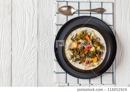 ground beef veggies kale soup in black bowl 118852929