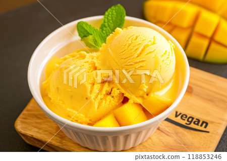 Vegetarian mango fruit ice cream on a wooden stand, delicious lactose-free dessert 118853246