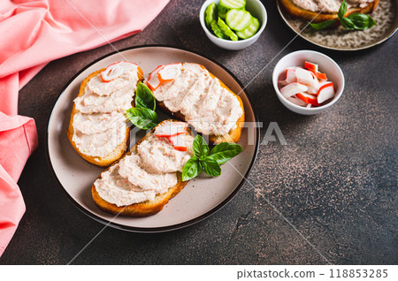 Delicious sandwiches with crab meat and cucumber pate on a plate on the table 118853285