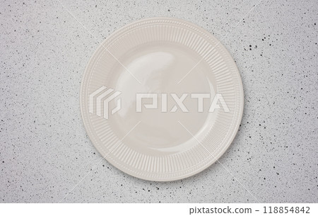 Empty round ceramic plate and a white background, top view 118854842