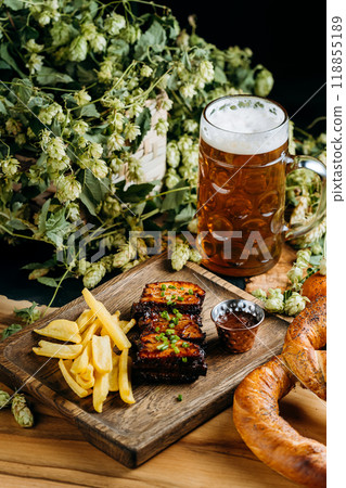 Beer with roasted ribs and French fries, perfect meal for a traditional pub or restaurant setting Beer with roasted ribs and French fries, perfect meal for a traditional pub or restaurant setting 118855189