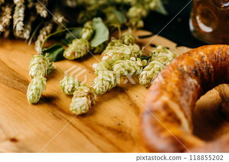Fresh hops on a wooden table, symbolizing natural brewing ingredients used in craft beer production 118855202