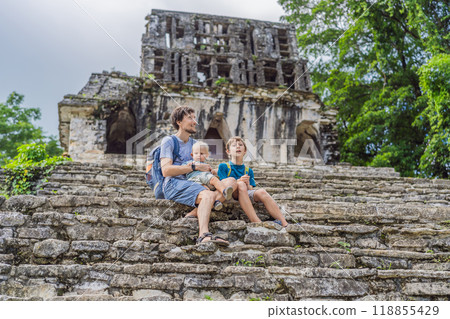 Father with his toddler and teenage sons exploring the ancient pyramids of Palenque, Mexico, surrounded by dense jungle. Cultural heritage and adventure travel concept Father with his toddler and teenage sons exploring the ancient pyramids of Palenque, Mexico, surrounded by dense jungle. Cultural heritage and adventure travel concept 118855429
