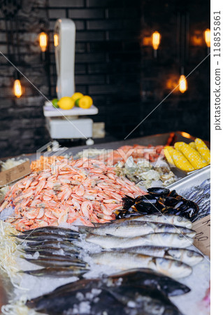 Fresh seafood assortment on display with fish, shrimp, and mussels on ice at seafood market counter 118855861