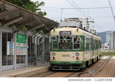 Hiroshima Electric Railway Tram 58 3100 Series No. 3103 in front of the Atomic Bomb Dome Hiroshima Electric Railway Tram 58 3100 Series No. 3103 in front of the Atomic Bomb Dome 118855948