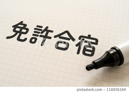 A notebook and marker with the words "Driver's License Training Camp" written on it A notebook and marker with the words "Driver's License Training Camp" written on it 118856160