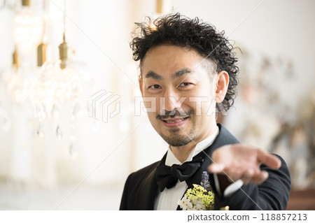 A bearded man in a tuxedo escorting 118857213