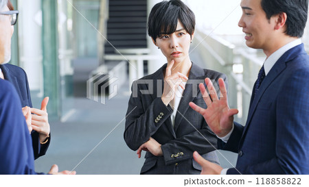 A female business person who is worried alone in a group A female business person who is worried alone in a group 118858822