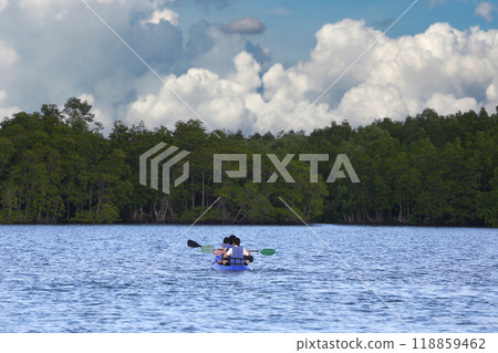 Tourists are kayaking in the middle of the sea and there are mangrove forests on the coast. Tourists are kayaking in the middle of the sea and there are mangrove forests on the coast. 118859462