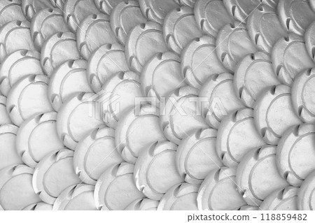 White patterns of stucco shaped like fish scales. White patterns of stucco shaped like fish scales. 118859482