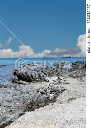 Coastal rocks after low tide against a blue sky at Samae San Bay. Coastal rocks after low tide against a blue sky at Samae San Bay. 118859987