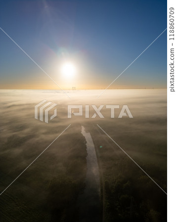 A Serene and Beautiful Sunrise Over a Misty Landscape with a Gentle River Flowing Through A Serene and Beautiful Sunrise Over a Misty Landscape with a Gentle River Flowing Through 118860709