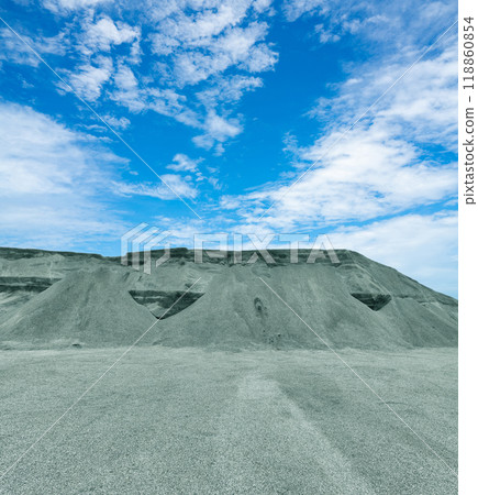 Industrial pile of mined crushed stone at limestone quarry, used for construction materials. Raw material mining for infrastructure projects. Limestone quarry production for construction industry. 118860854