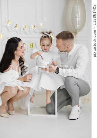 Happy family celebrating toddler's second birthday at home Happy family celebrating toddler's second birthday at home 118861408