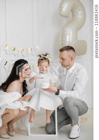 Family celebrates child's birthday with joy and love Family celebrates child's birthday with joy and love 118861416