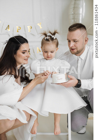 Happy family celebrating daughter's second birthday together 118861434